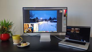 Apple Pro Display XDR on a desk showing a photo editing app open
