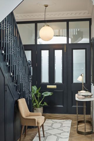 dark blue hallway with side table and chair