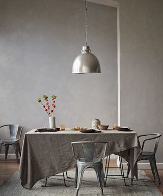 Grey dining area and metal pendant light by Crown