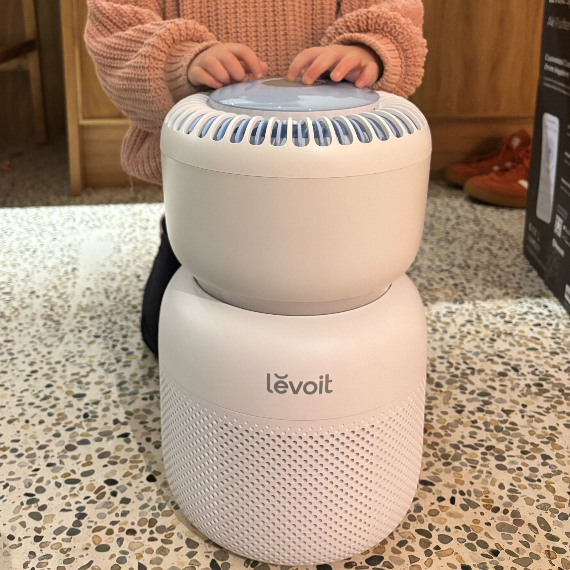 levoit sprout air purifier with child hands