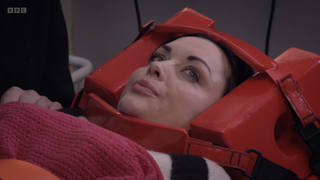Whitney Dean wearing a head immobilizer in hospital.