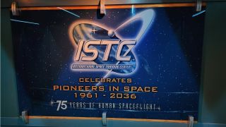 The ISTC celebration signage in the Mission: Space queue.