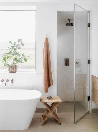 white bathtub with shower cubicle