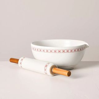 Stoneware Mixing Bowl and Rolling Pin Set against a gray background. 