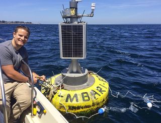 Author Matthew Savoca deploys experimental plastic debris at a buoy in Monterey Bay, California.