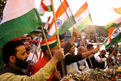 Kashmiri men wave Indian National Flag during Tiranga rally In Baramulla Jammu