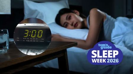 The image shows a dark haired woman lying in bed with her eyes open. A blue cloud-shaped Tom's Guide Sleep Week 2026 is overlaid on top of the image in the bottom right hand corner.