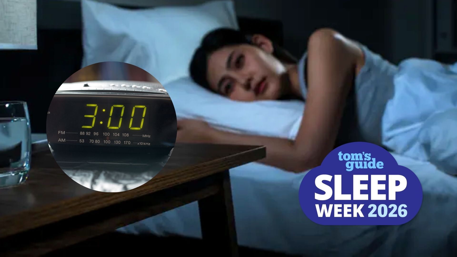 The image shows a dark haired woman lying in bed with her eyes open. A blue cloud-shaped Tom's Guide Sleep Week 2026 is overlaid on top of the image in the bottom right hand corner.