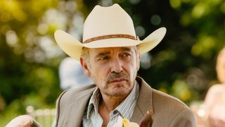 Tommy in cowboy hat sitting outside poolside in Landman Season 2