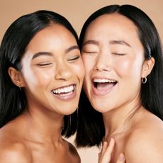 two models with perfect skin laughing