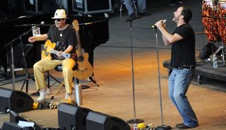 Carlos Santana (left) and Dave Matthews perform at the Bridge School Benefit at the Shoreline Amphitheatre in Mountain View, California on October 23, 2011