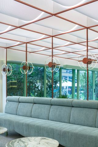 Seating area with mirrored walls and copper detail at Infinity Wellbeing, Bangkok
