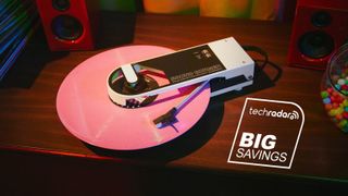 A white Audio-Technica Sound Burger turntable with a pink record inserted.