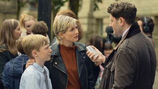 Susan and her son Connor talk to the press outside the trial in Toxic Town