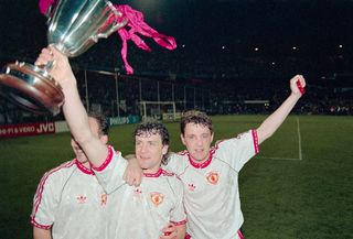 Manchester United striker Mark Hughes (c) celebrates with the trophy with team mates Mike Phelan (l) and Steve Bruce (r) after the 1991 European Cup Winners Cup Final between Manchester United and Barcelona on May 15th, 1991 in Rotterdam, Holland.