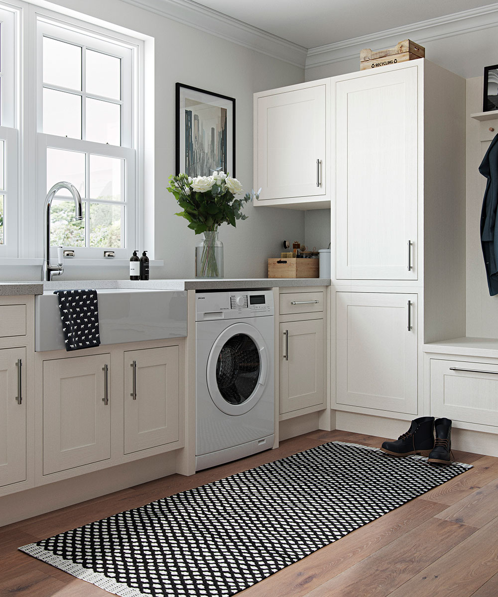 Cream painted utility room with wooden floor and monochrome rug