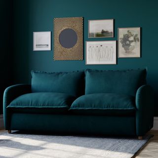 Teal sofa against a teal wall with gallery display