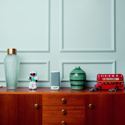 wooden cupboard with bluetooth speaker and toys