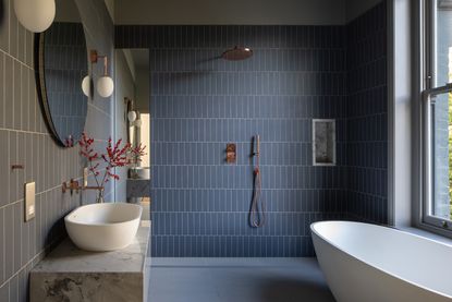 a blue bathroom with a marble niche