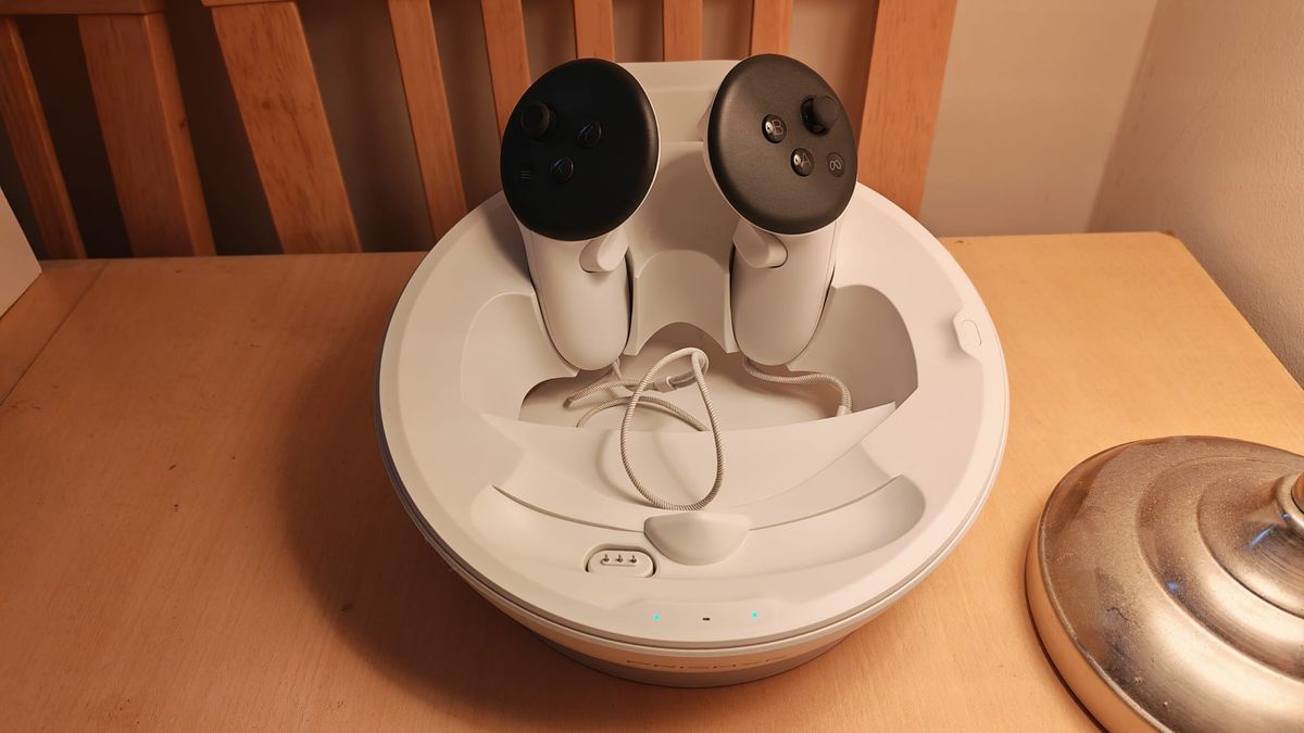 The PRismXR charging dock with the Quest 3 controllers cradled in it