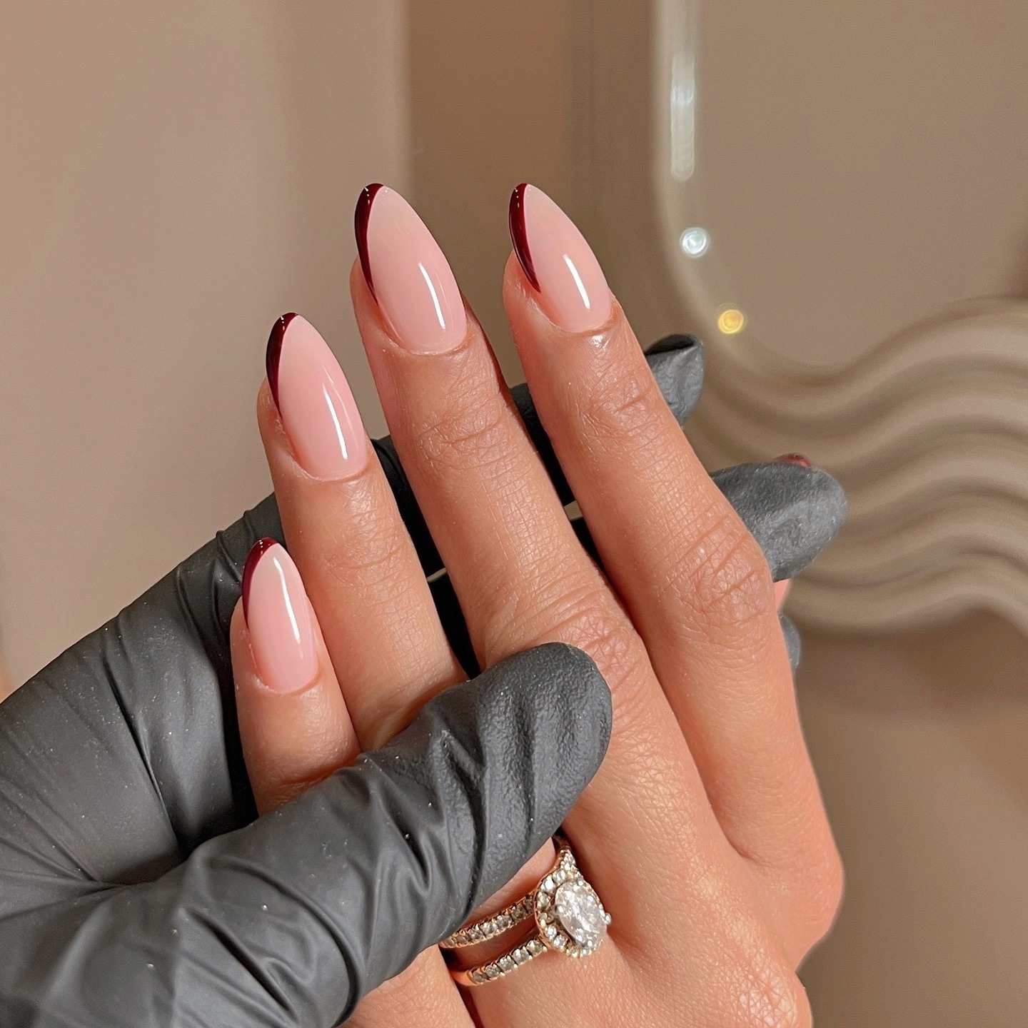 A glossy burgundy French tip nail design