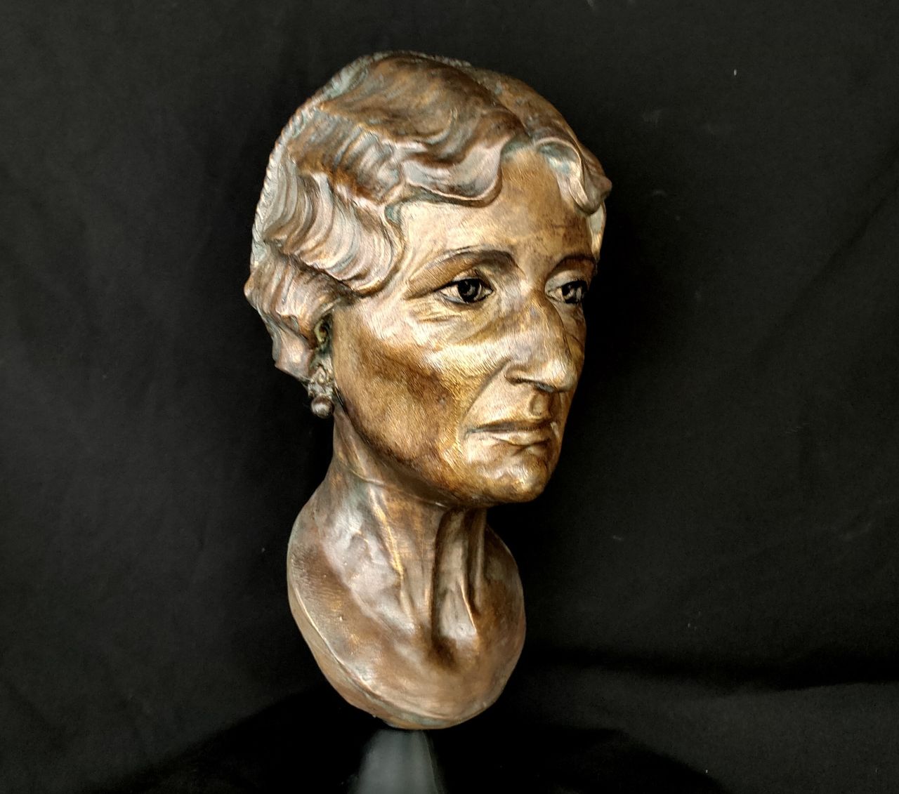 Bronze sculpture of a female mummy.