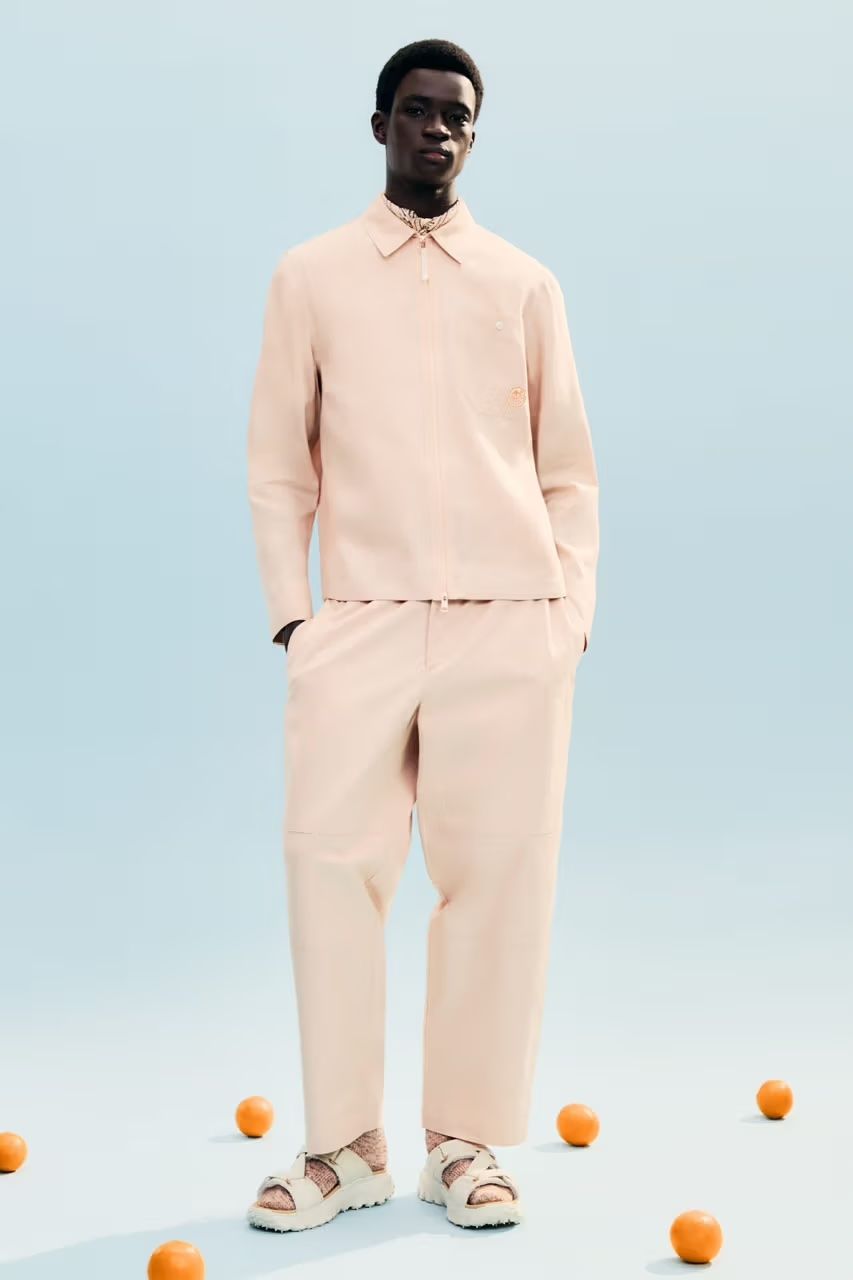 Moncler range on model including zip-up jacket in ecru with sandals