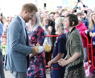 Daisy Wingrove, a 13-year-old former cancer patient, gifts Prince Harry a teddy bear for Archie in May at the Oxford Children’s Hospital.