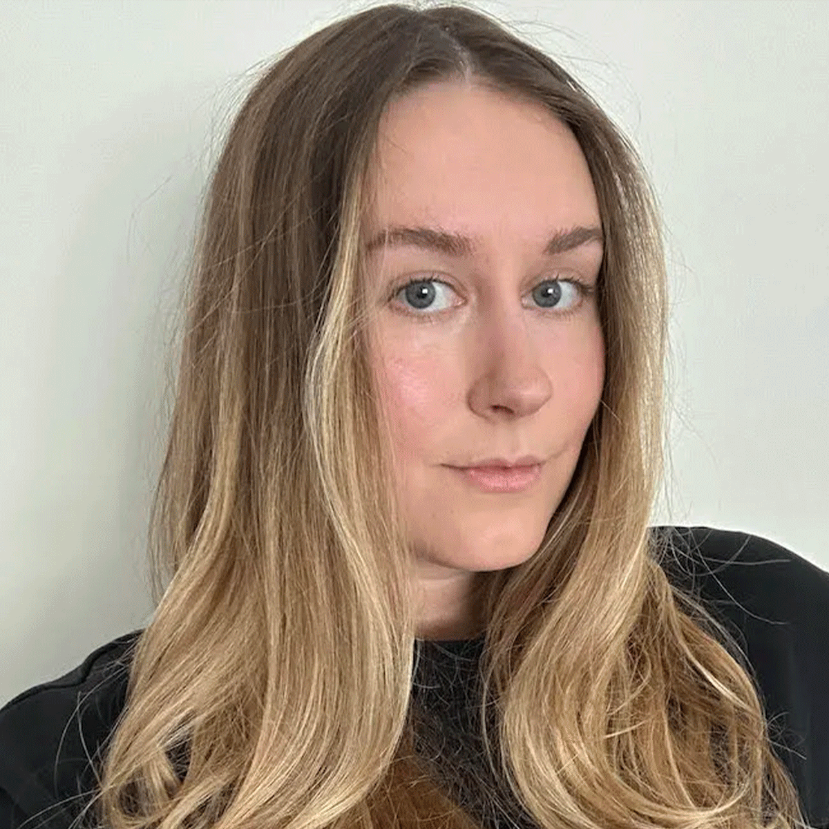 A GIF of Kaitlyn McLintock testing the best foundations for rosacea