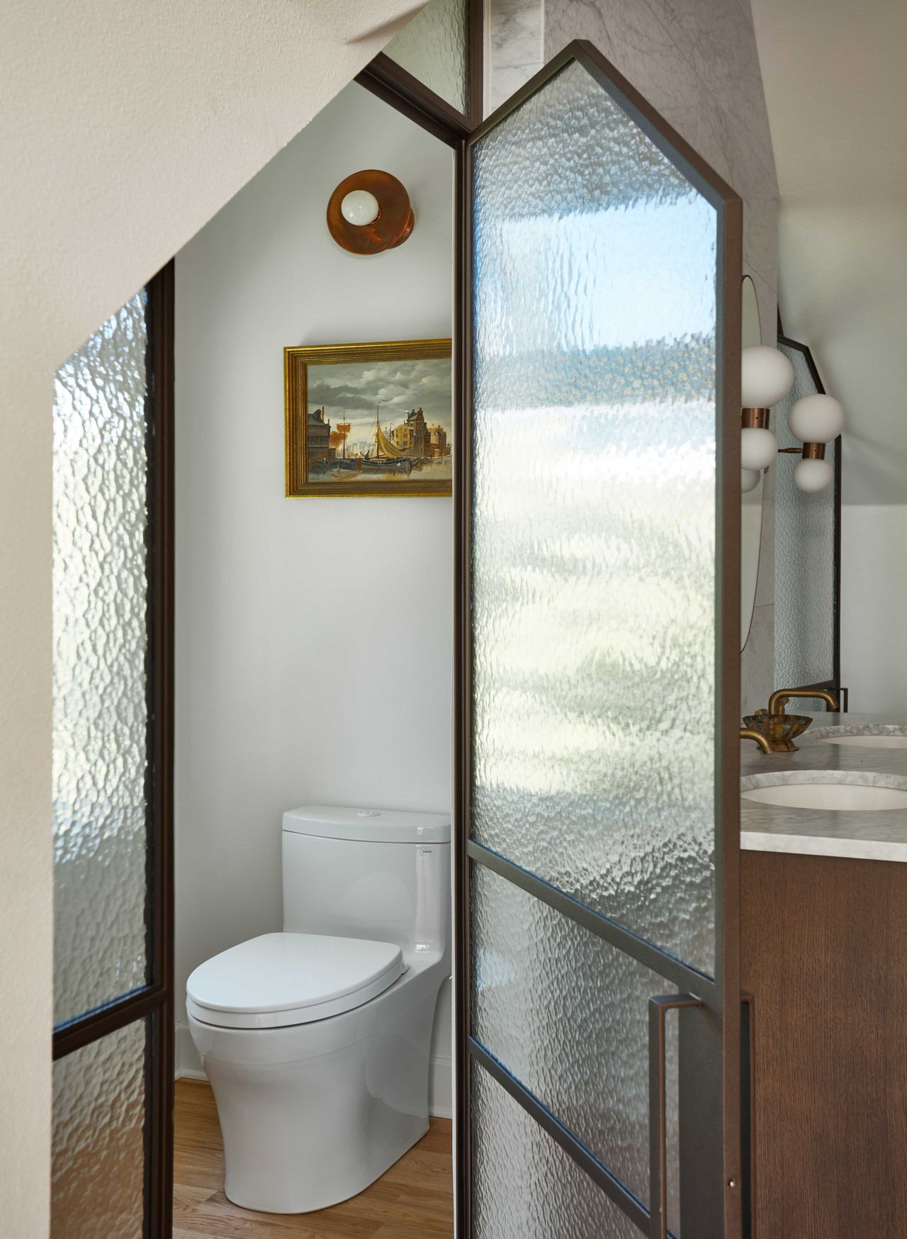 a bathroom with frosted glass around WC