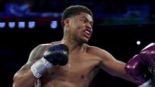Shakur Stevenson of the United States punches in blue boxing gloves ahead of the Stevenson vs De Los Santos fight. 