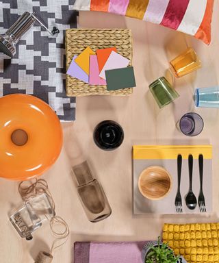 A flatlay with colorful decor, utensils, and swatches