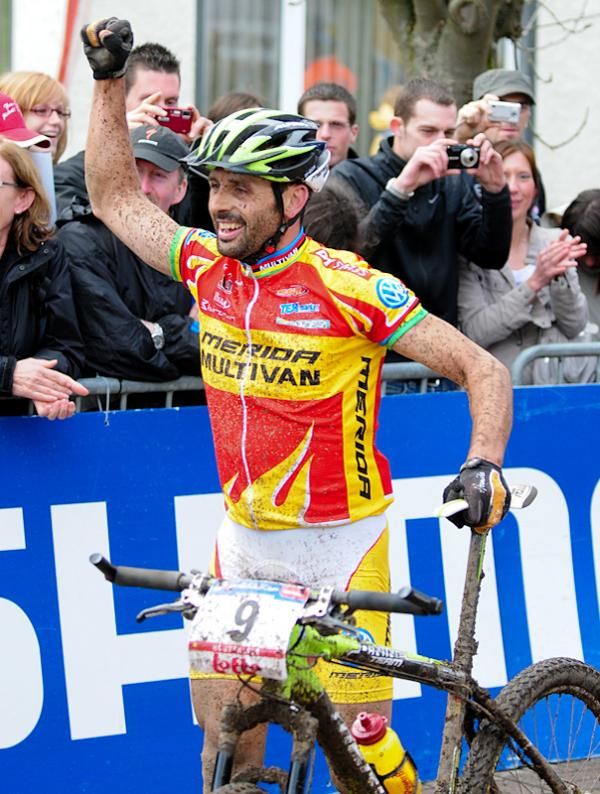 Jose Antonio Hermida Ramos (Multivan Merida Biking Team) celebrates his win after rolling his bike over the finish line.