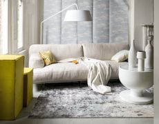 A living room with a cream linen sofa 