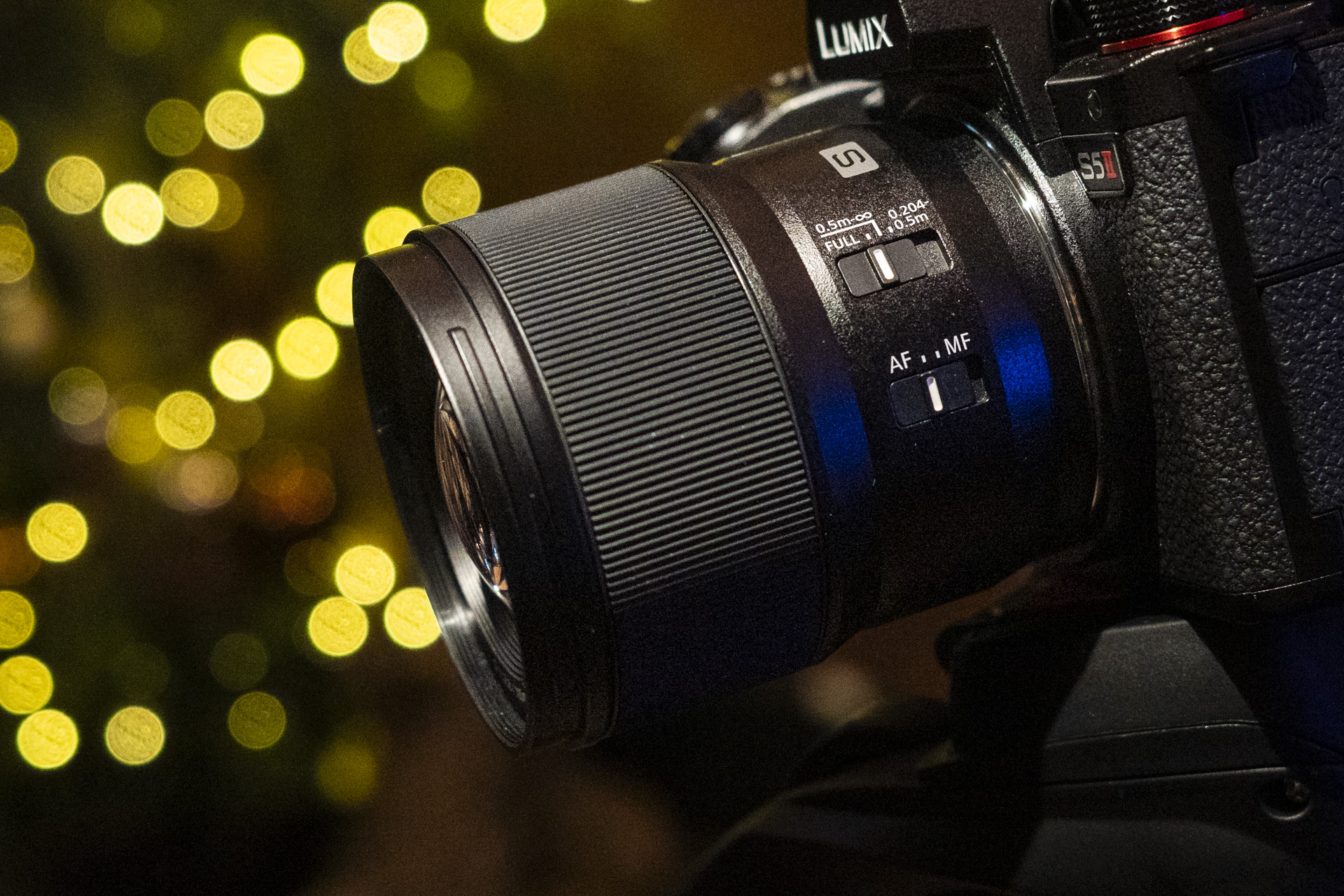 Panasonic Lumix S 100mm F2.8 Macro lens attached to a Lumix S5 II with Christmas light background