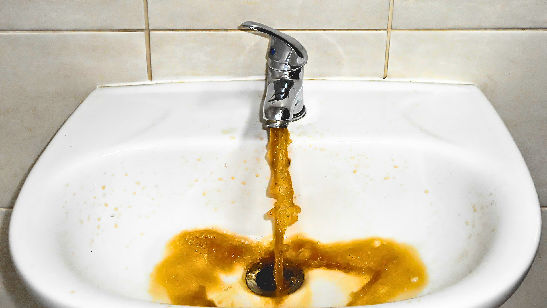 dirty water coming out of a tap