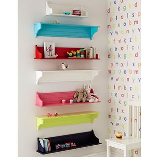 children's room with white wall and shelves with toys