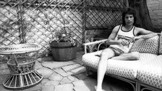 Queen’s Freddie Mercury sitting on an outdoor sofa at home in 1975