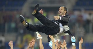 Barcelona´s coach Josep Guardiola (top) celebrates with players after the trophy ceremony of the final of the UEFA football Champions League on May 27, 2009 at the Olympic Stadium in Rome. Barcelona defeated Manchester United 2-0 to win the Cup.