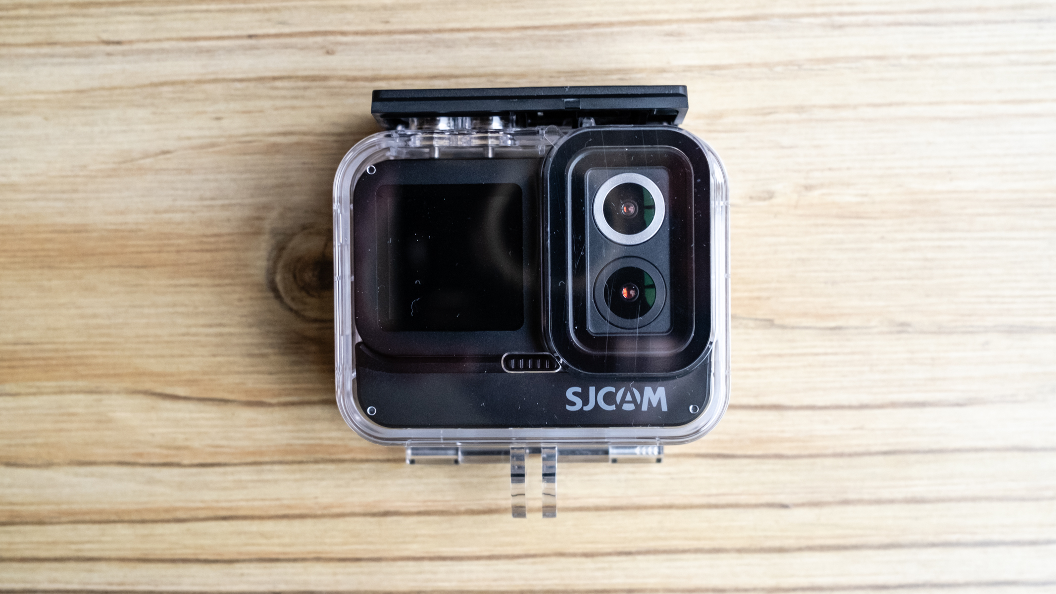SJCAM SJ20 action camera on a wooden floor