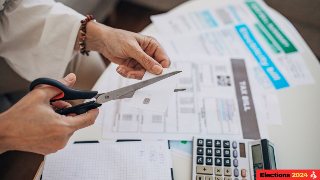 Person cutting up bills with a pair of scissors