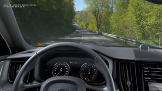 Still from Varjo’s XR-1 promotional video showing a virtual cockpit overlay on a physical car while driving. The view outside the windshield is the actual road.