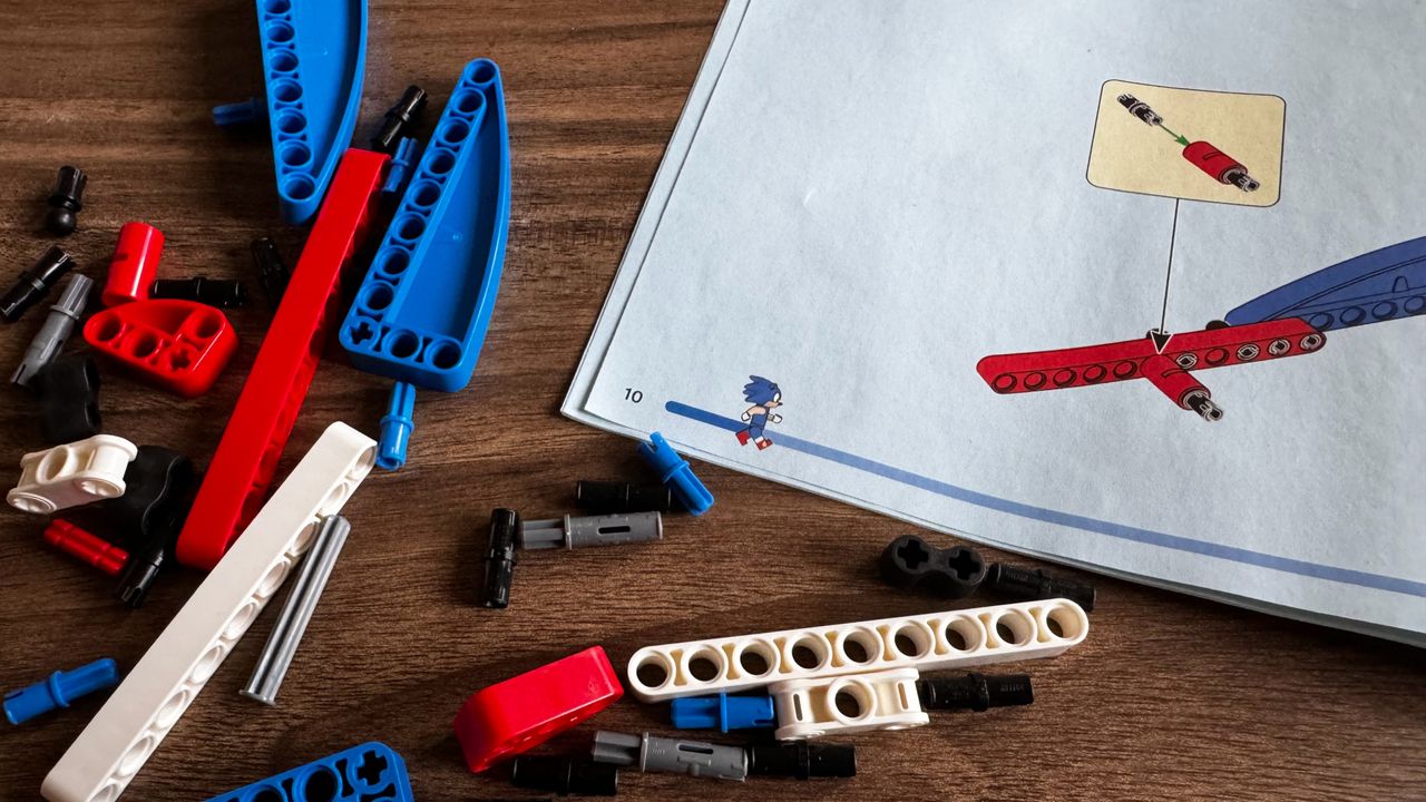 Lego Sonic vs. Dr. Eggman's Death Egg Robot set under construction on a wooden table