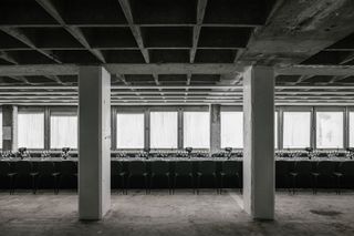 bare concrete space with glasses on tables