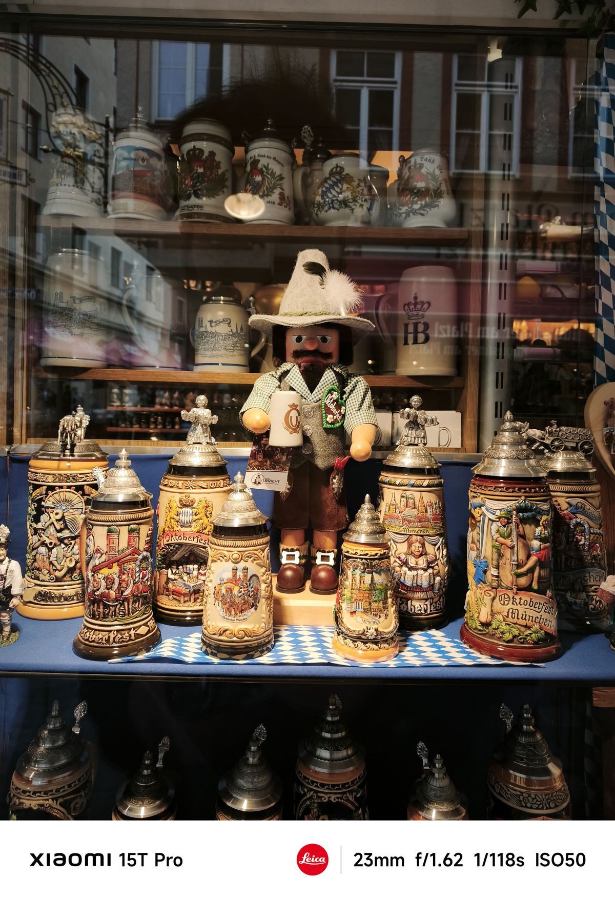 A doll surrounded by ornate beer mugs in Munich, Germany