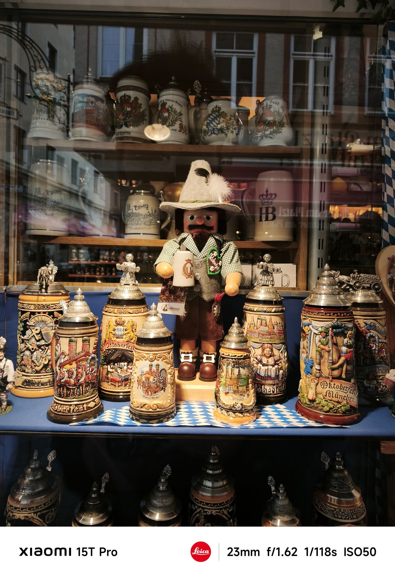 A doll surrounded by ornate beer mugs in Munich, Germany