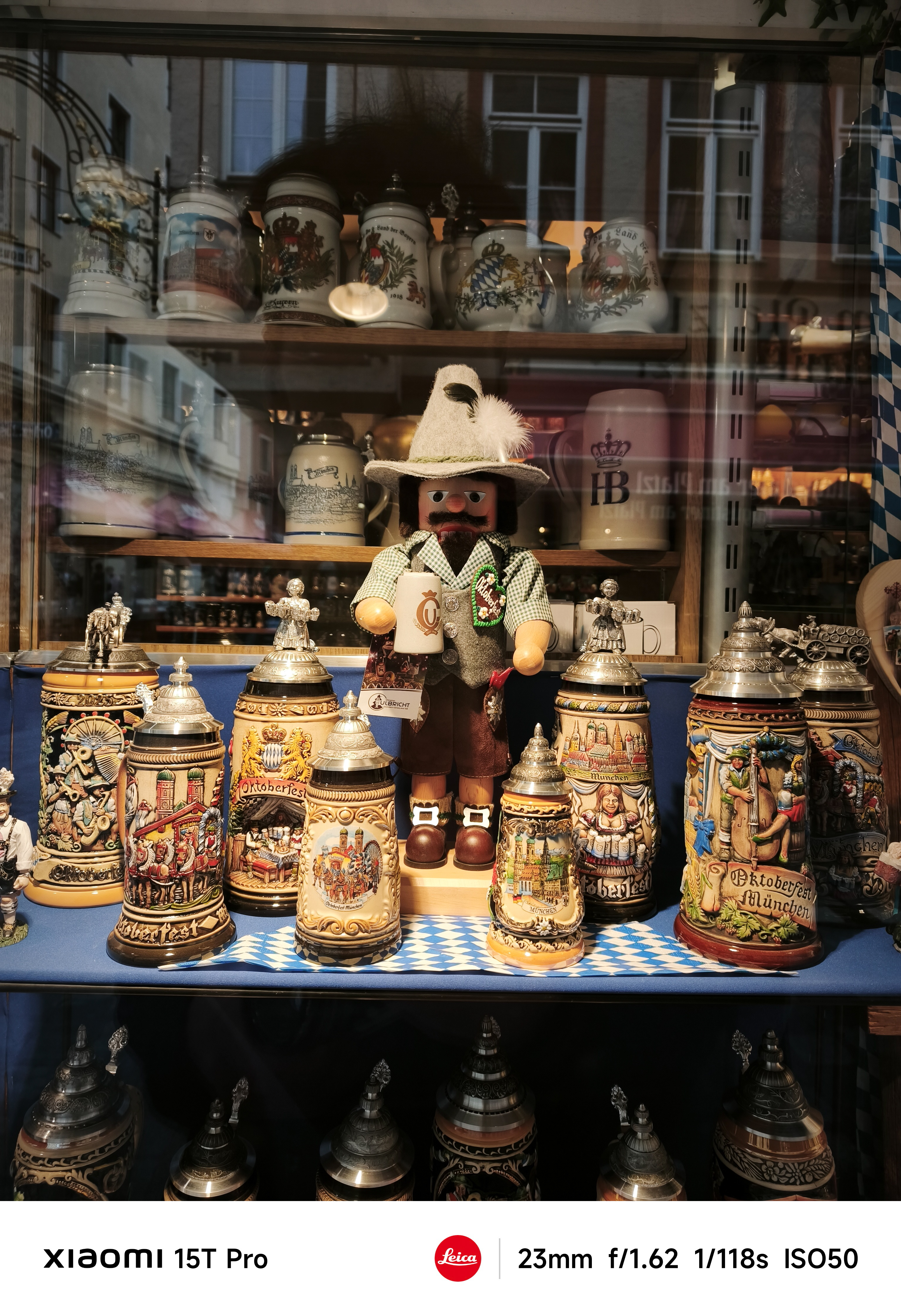 A doll surrounded by ornate beer mugs in Munich, Germany