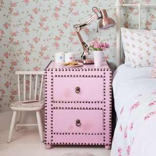 bedroom with pink floral printed wall and pink wardrobe