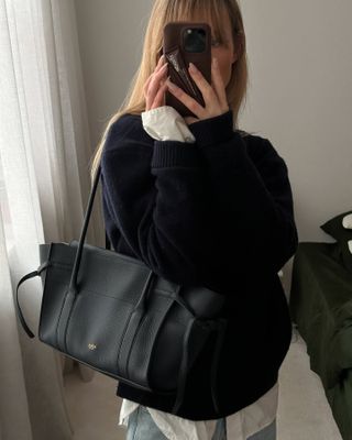 Woman carries black soft bayswater mulberry bag