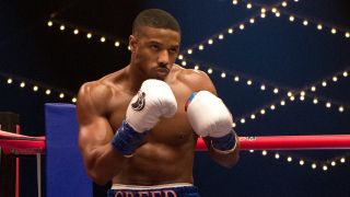 Michael B. Jordan fists raised in the boxing ring in Creed II